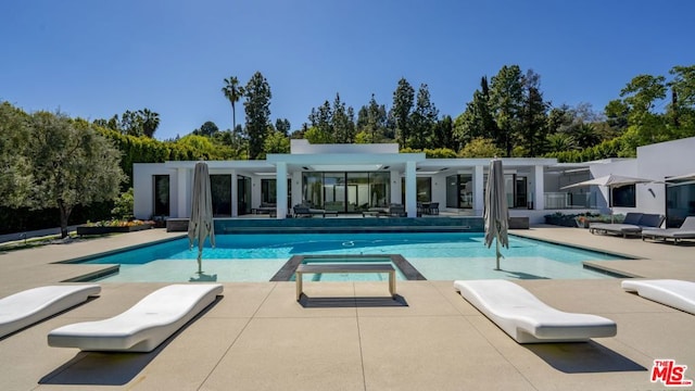 view of swimming pool featuring an in ground hot tub and a patio area