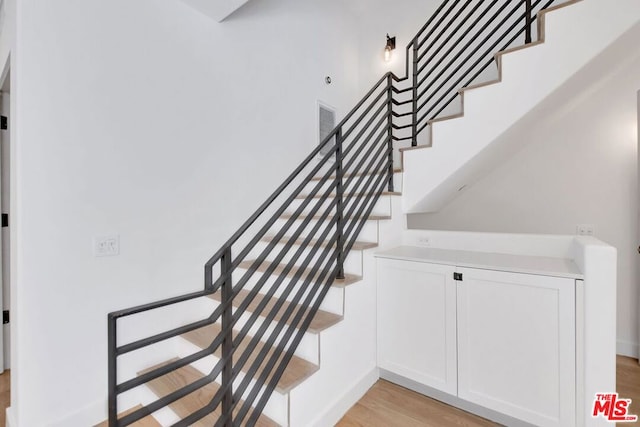 staircase featuring hardwood / wood-style floors