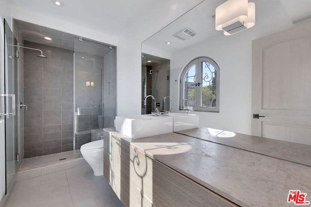 bathroom featuring tile patterned flooring, vanity, a shower with shower door, and french doors