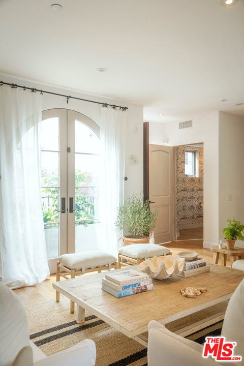 living room with wood-type flooring and french doors