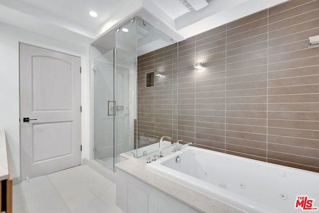 bathroom with tile patterned floors and separate shower and tub