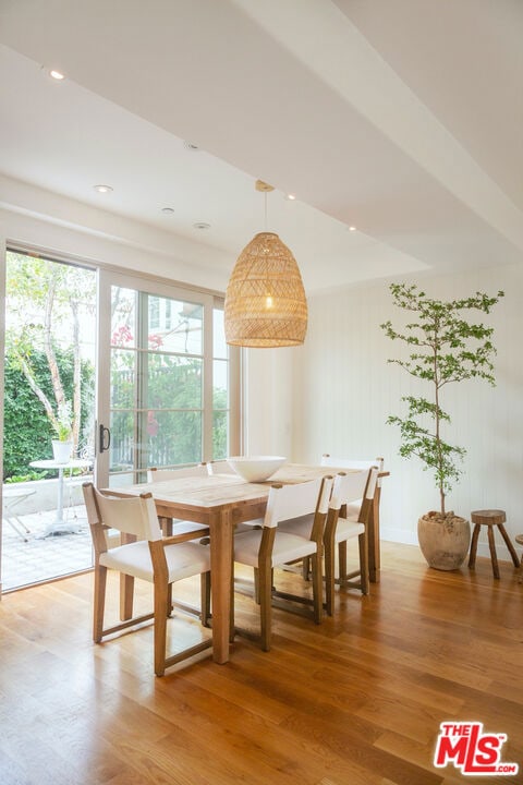 dining space with wood-type flooring