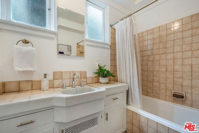 bathroom featuring vanity and shower / tub combo with curtain