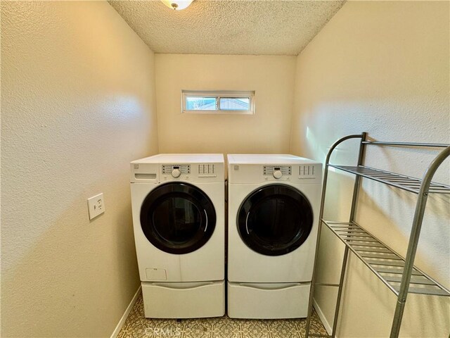 clothes washing area featuring a textured ceiling and independent washer and dryer