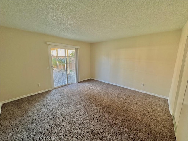 carpeted empty room with a textured ceiling