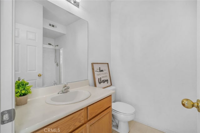 bathroom with toilet, vanity, and an enclosed shower