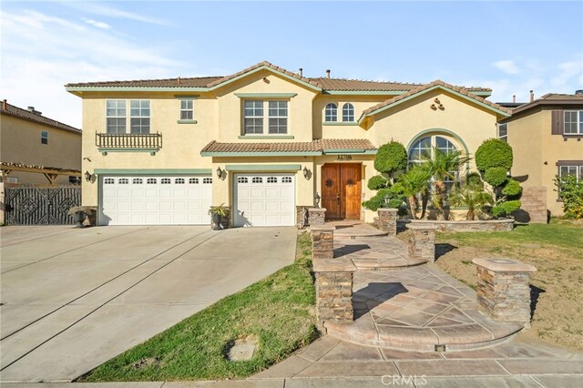 mediterranean / spanish home with a garage