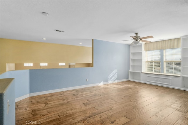 spare room featuring ceiling fan and hardwood / wood-style floors