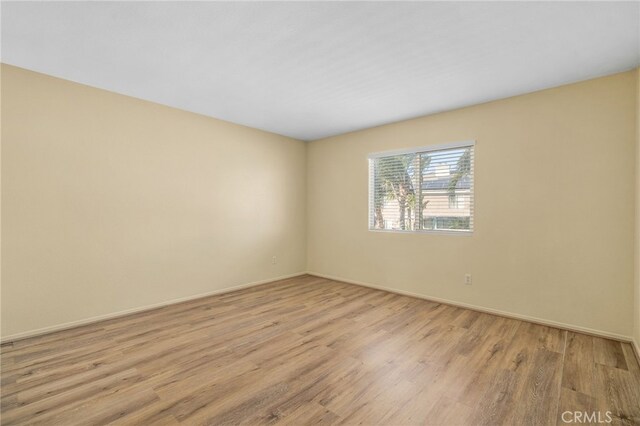 spare room featuring light wood-type flooring