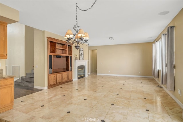 unfurnished living room with a notable chandelier