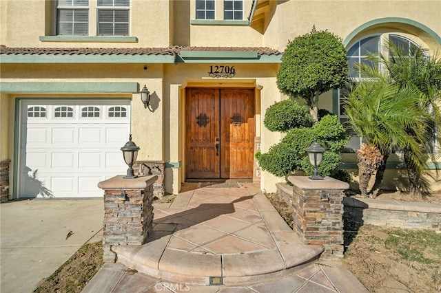 view of exterior entry featuring a garage