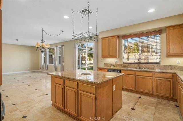 kitchen with a kitchen island, black dishwasher, an inviting chandelier, sink, and light stone counters