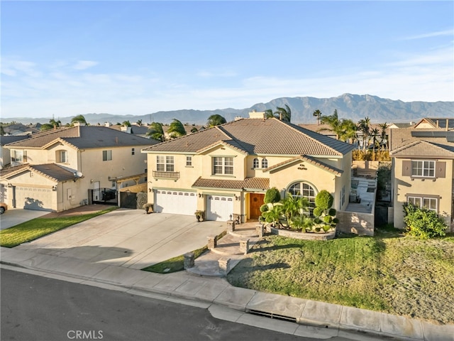 mediterranean / spanish-style home with central AC unit, a garage, and a mountain view