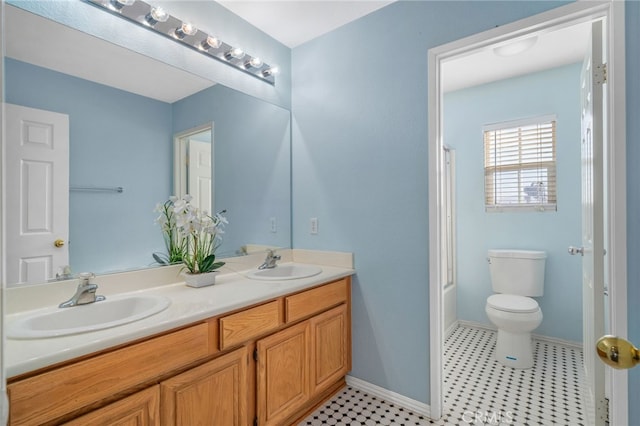 full bathroom with toilet, bath / shower combo with glass door, and vanity