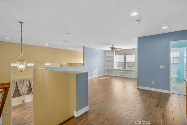 kitchen featuring decorative light fixtures, wood-type flooring, and ceiling fan