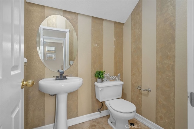 bathroom featuring toilet and tile patterned flooring