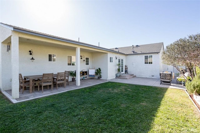 back of house featuring a lawn and a patio