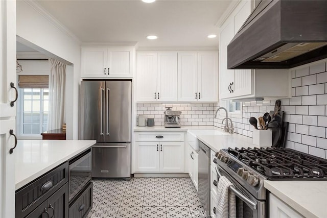 kitchen with exhaust hood, white cabinetry, stainless steel appliances, backsplash, and sink