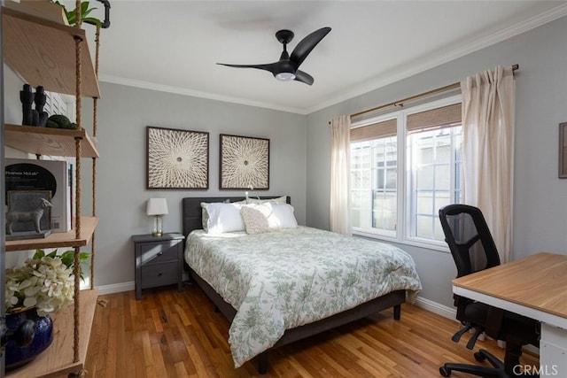 bedroom with ceiling fan, hardwood / wood-style flooring, and crown molding