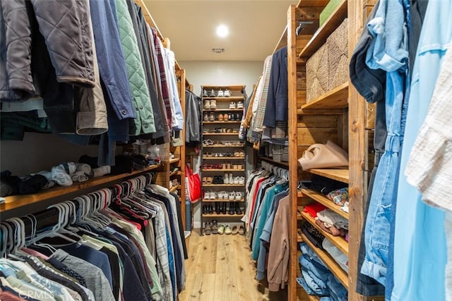 spacious closet featuring light hardwood / wood-style floors