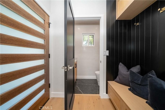 bathroom with toilet and hardwood / wood-style flooring