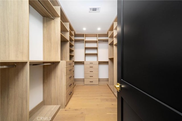 spacious closet with light hardwood / wood-style floors