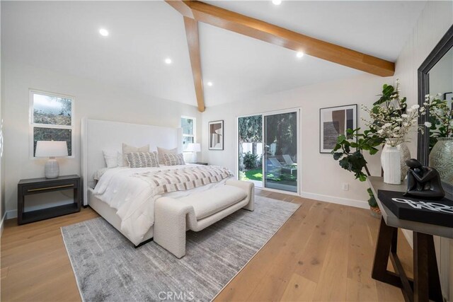 bedroom featuring lofted ceiling with beams and light hardwood / wood-style floors