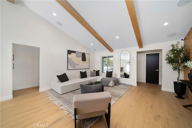 living room with high vaulted ceiling, light hardwood / wood-style flooring, and beam ceiling