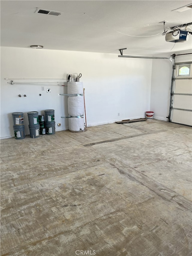 garage featuring water heater and a garage door opener