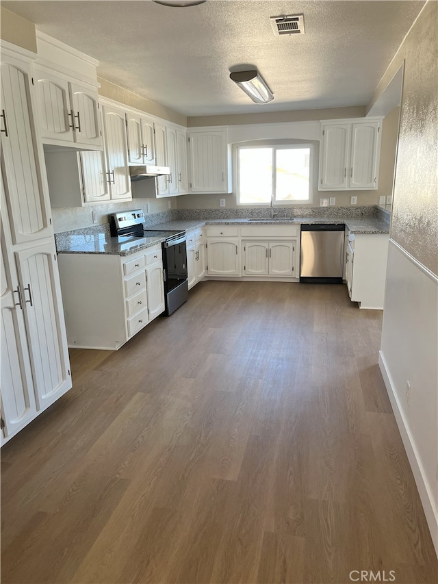 kitchen featuring white cabinetry, sink, stainless steel appliances, and stone counters