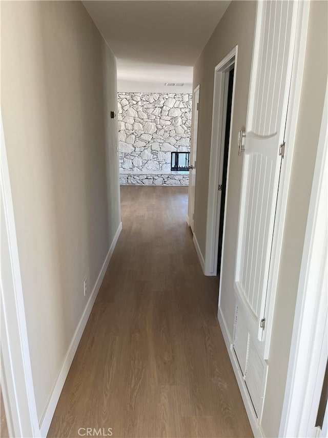 hallway with hardwood / wood-style flooring