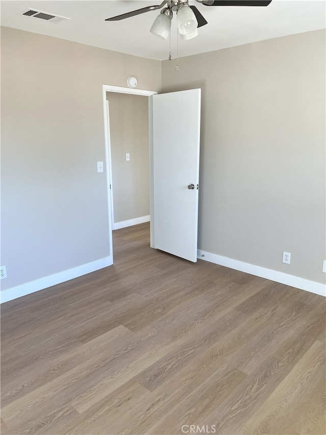 unfurnished room with ceiling fan and light hardwood / wood-style floors