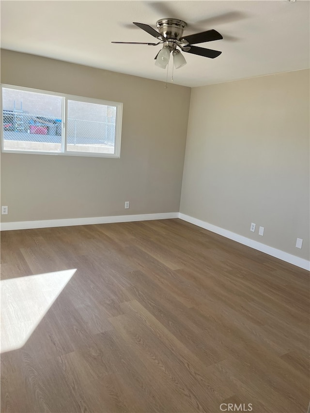 spare room featuring hardwood / wood-style floors and ceiling fan