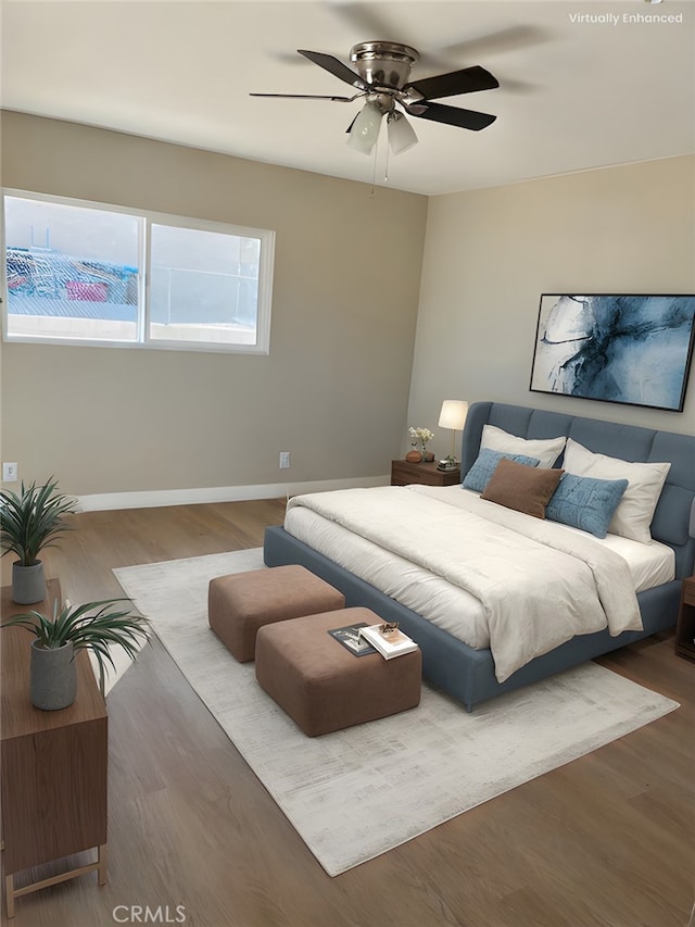 bedroom featuring dark hardwood / wood-style flooring and ceiling fan