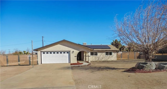 view of front of house with a garage and solar panels