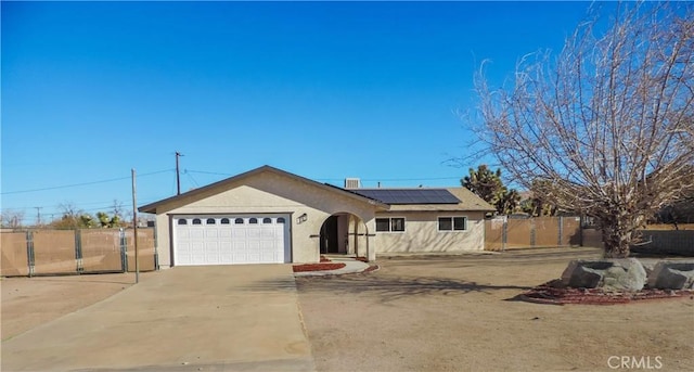 view of front of house featuring a garage and solar panels