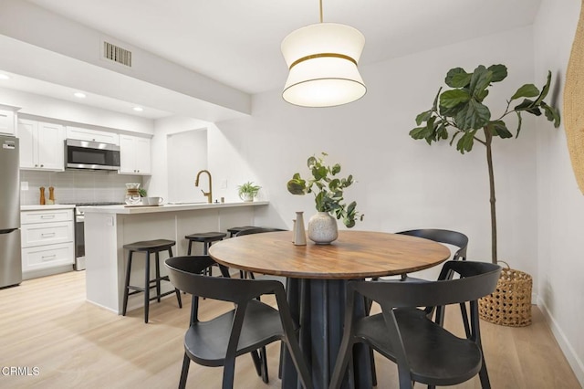 dining room featuring light hardwood / wood-style flooring