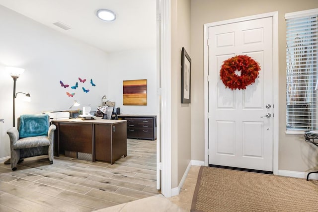 foyer entrance with light hardwood / wood-style flooring