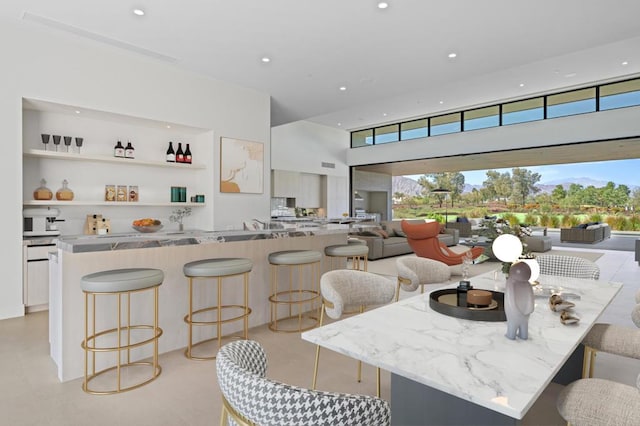 dining area with plenty of natural light and a towering ceiling