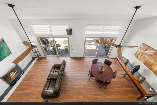 exercise room featuring a fireplace, a textured ceiling, and hardwood / wood-style floors