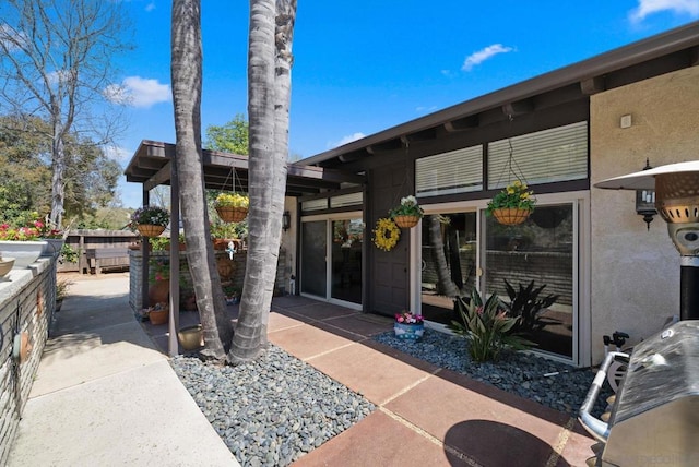 doorway to property with a patio area