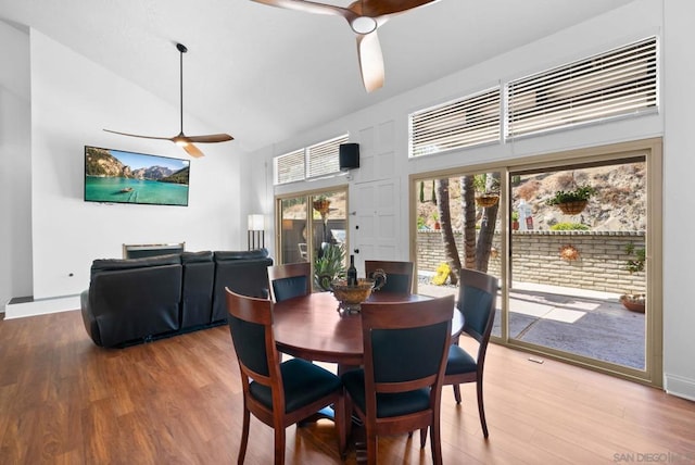 dining area with french doors, ceiling fan, hardwood / wood-style floors, and high vaulted ceiling