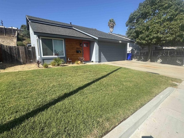 view of front of house with a garage and a front yard