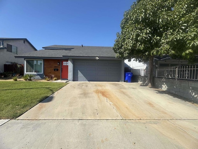 ranch-style home with a front yard and a garage