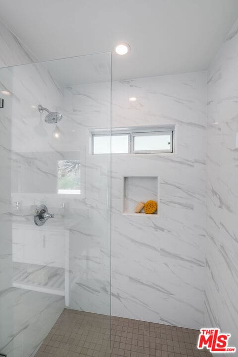 bathroom with tiled shower