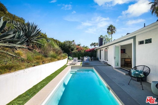 view of pool featuring a patio