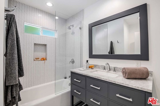 bathroom featuring vanity and tiled shower / bath combo