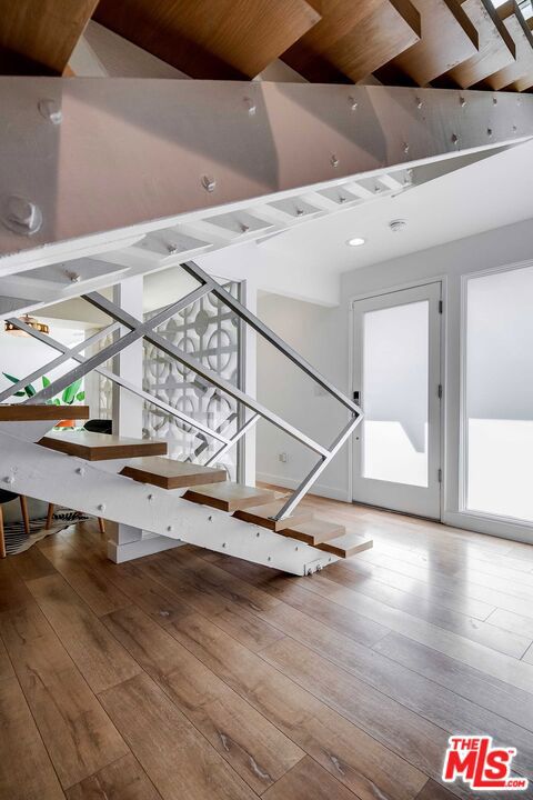 stairs featuring wood-type flooring