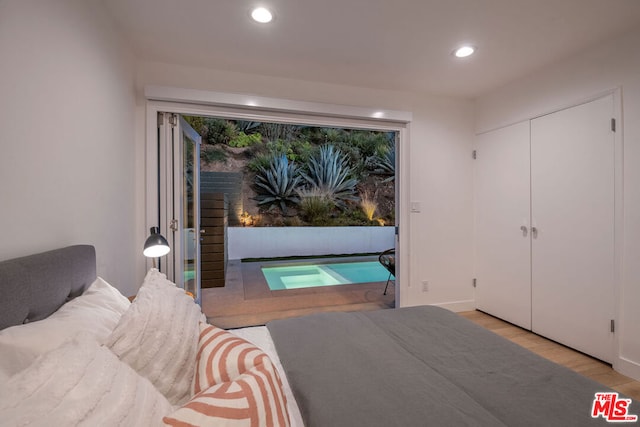 bedroom featuring access to exterior and light hardwood / wood-style floors