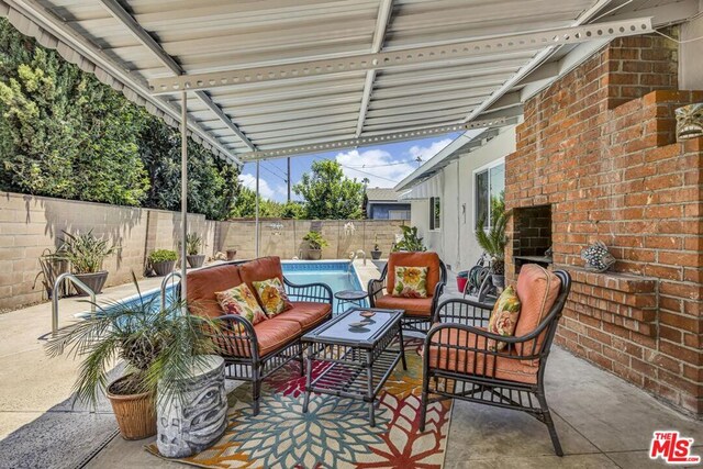 view of patio featuring an outdoor hangout area and a fenced in pool